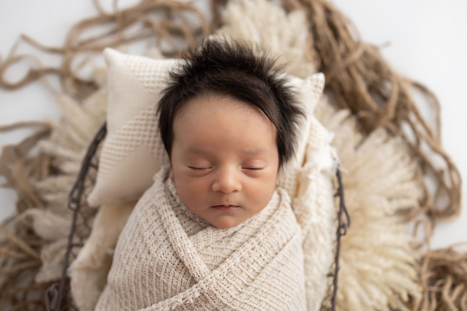 Adult hands gently cradling tiny newborn baby feet, symbolizing love and new parenthood.