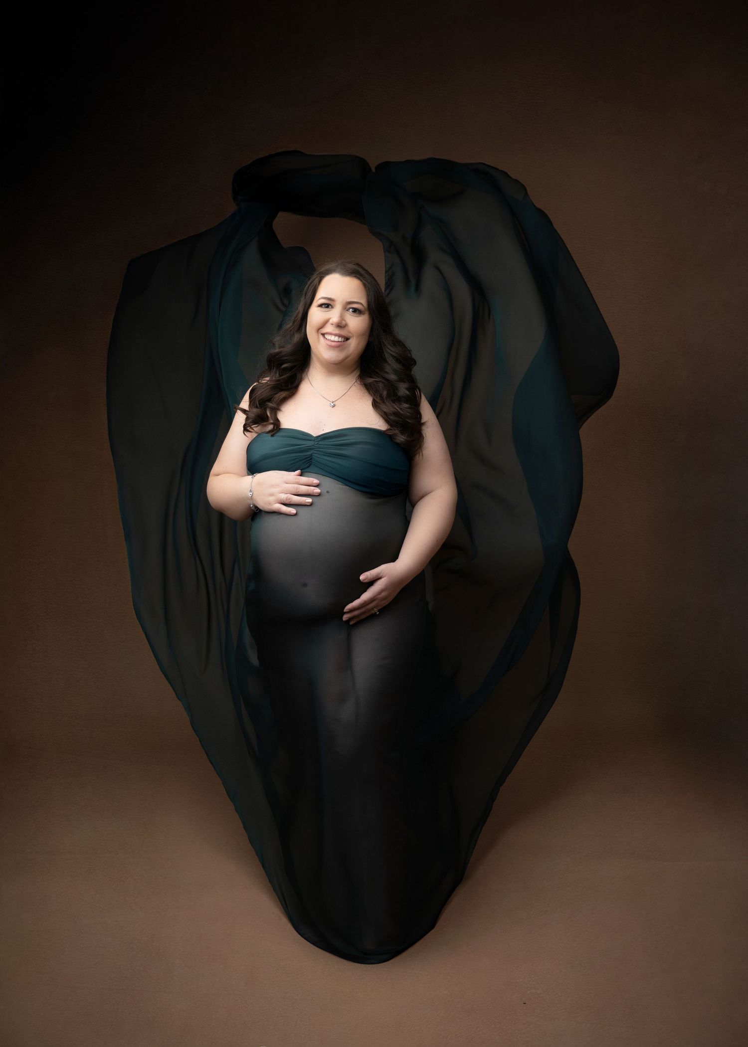 Teal flowing fabric behind pregnant mom with twins in linden NJ studio