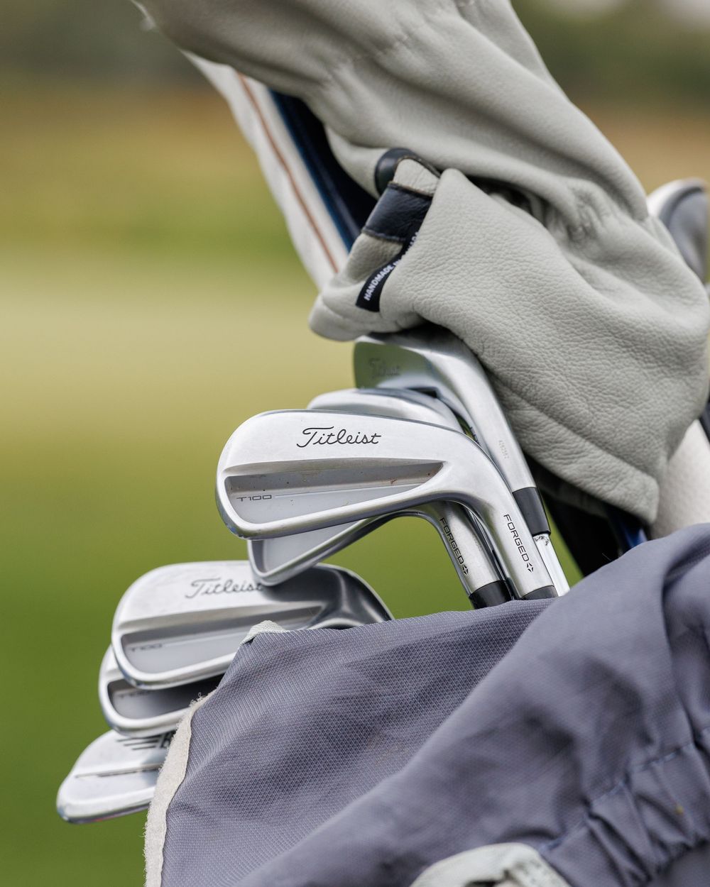 Close-up of Titleist irons in a golf bag ready for play on the course.