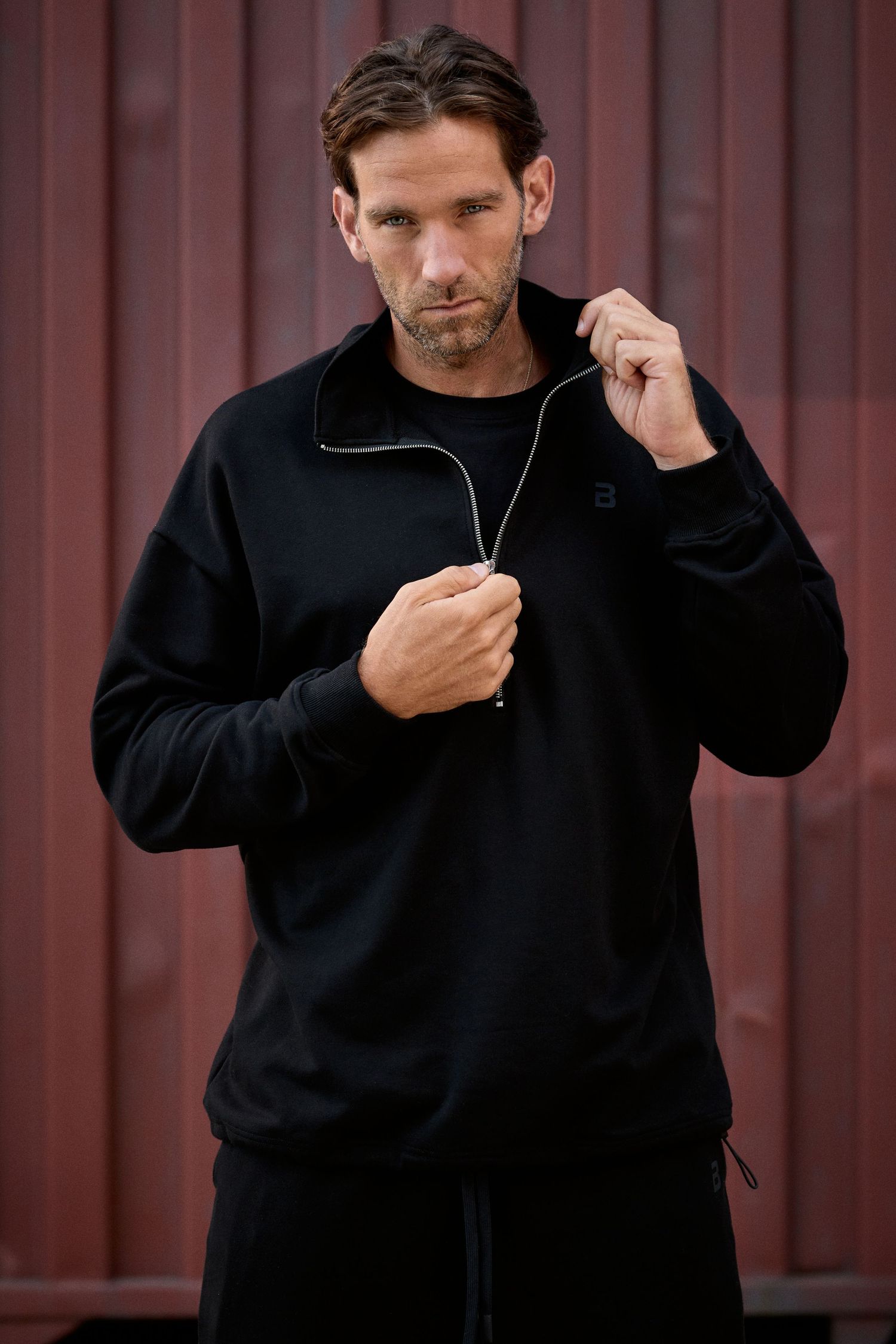 Model wearing BioTechUSA FW26 apparel in an industrial Budapest location
