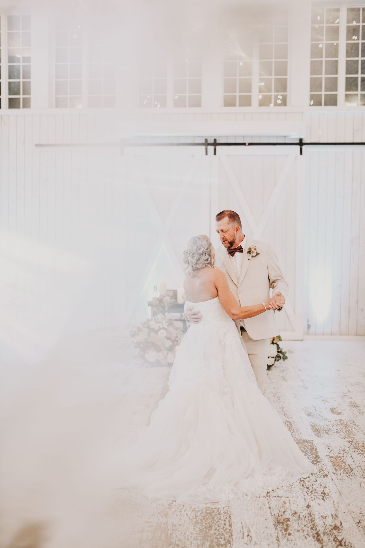 Bride and groom enjoying a joyful reception surrounded by their family