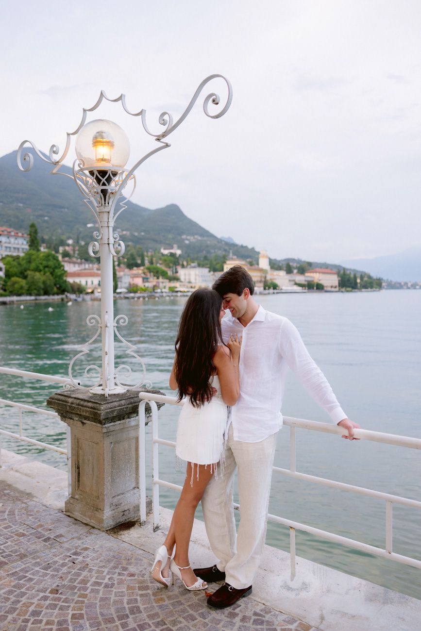 Romantic portrait of bride and groom during the welcome party of their destination wedding by the shores of Lake Garda. Solidea Events