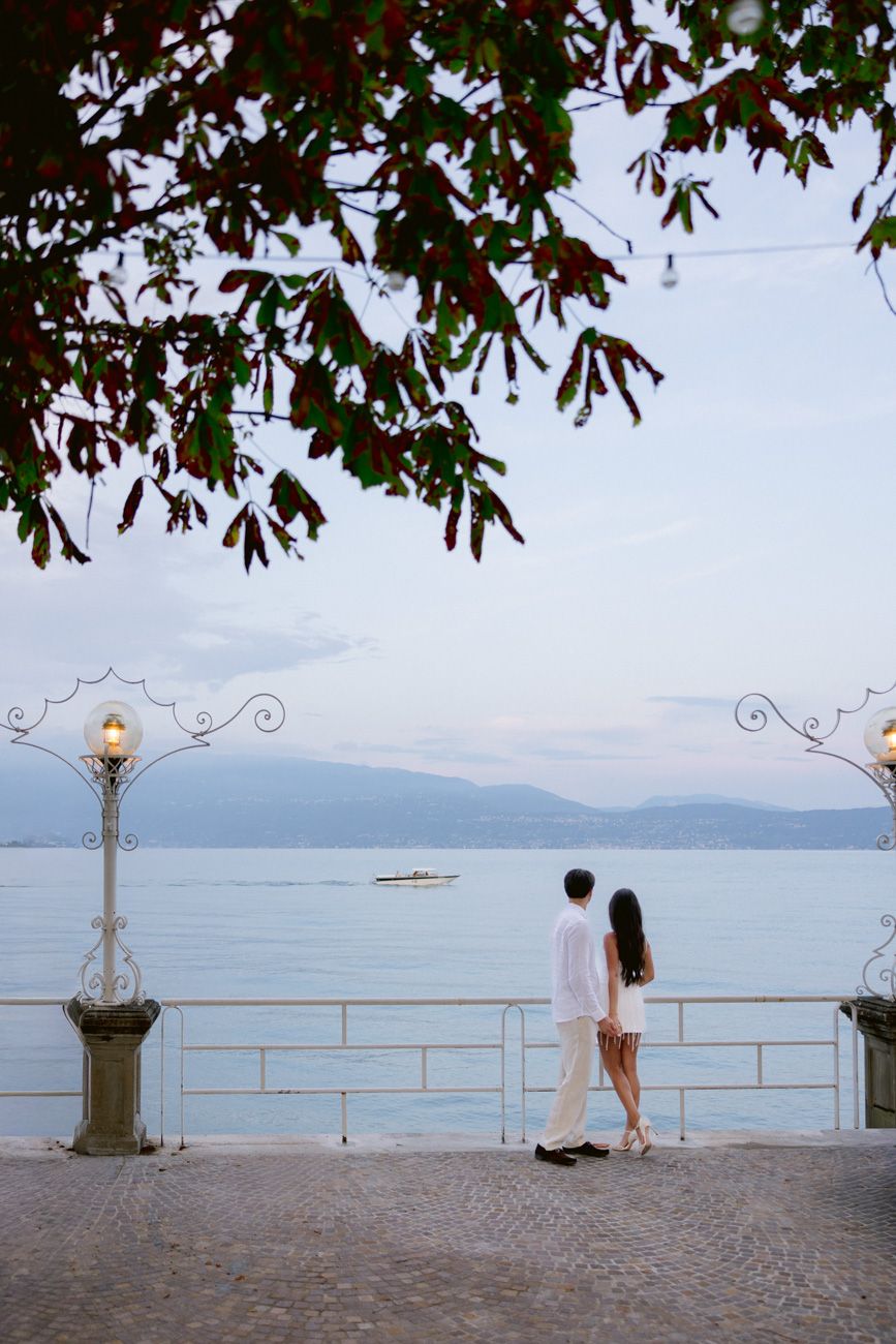 Romantic portrait of bride and groom during the welcome party of their destination wedding by the shores of Lake Garda. Solidea Events