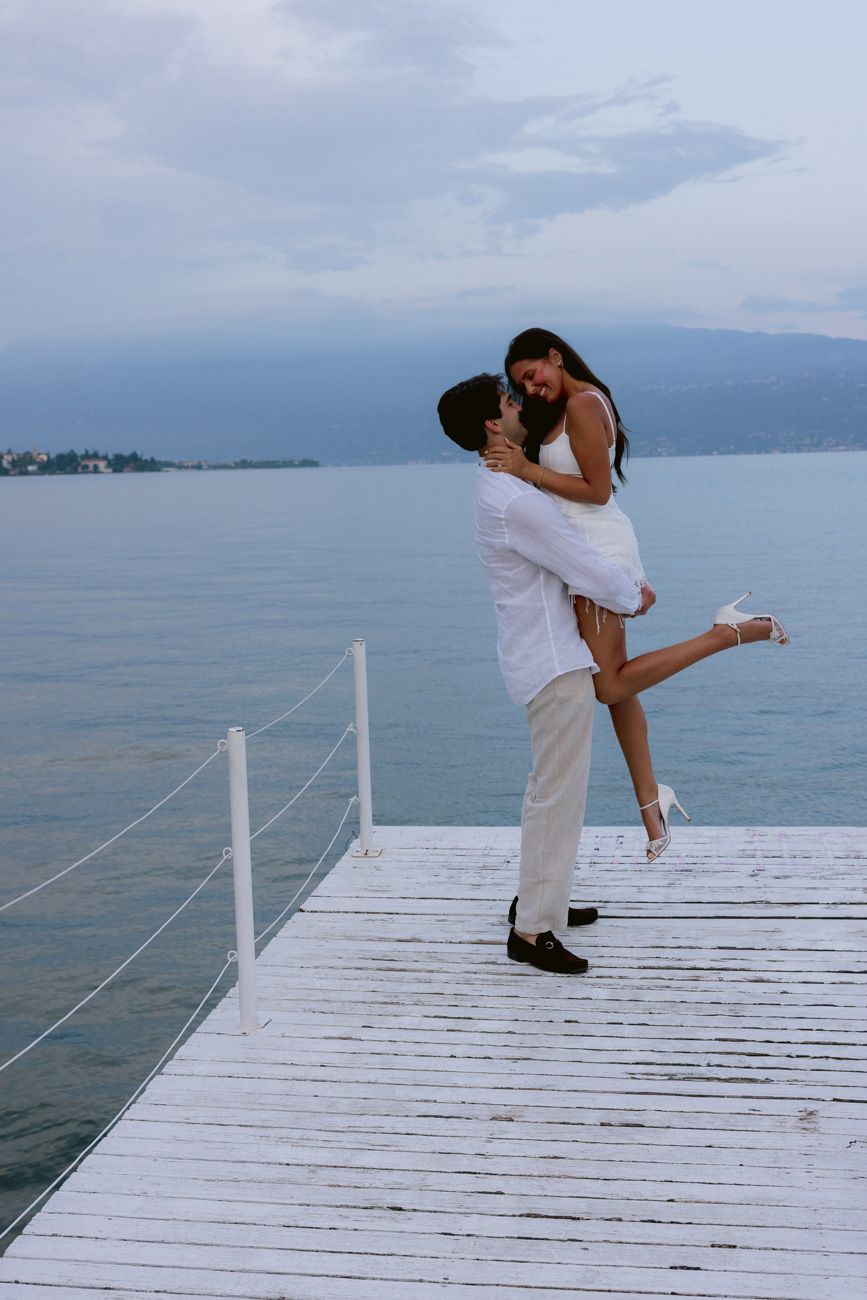 Romantic portrait of bride and groom during the welcome party of their destination wedding by the shores of Lake Garda. Solidea Events