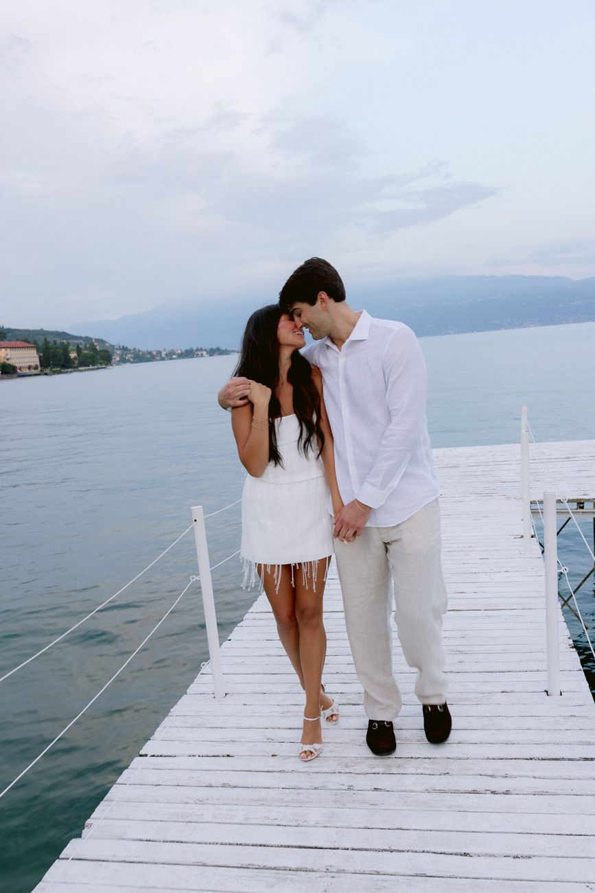 Romantic portrait of bride and groom during the welcome party of their destination wedding by the shores of Lake Garda. Solidea Events