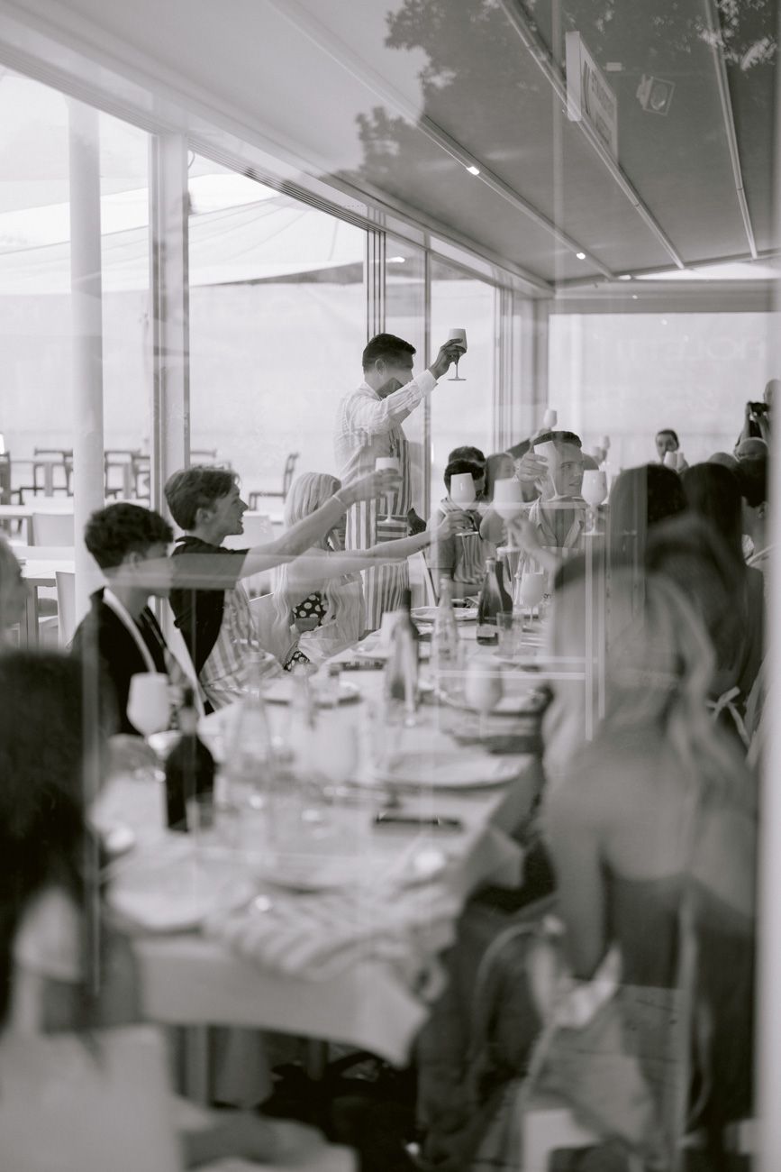Guests celebrating during a welcome party of a destination wedding by the shores of Lake Garda. Planned by Solidea Events