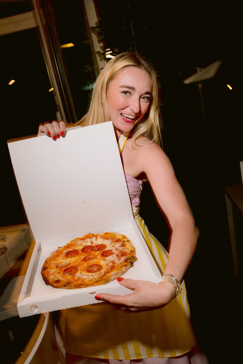 Guest with her pizza made during a welcome party by the shores of Lake Garda. Planned by Solidea Events