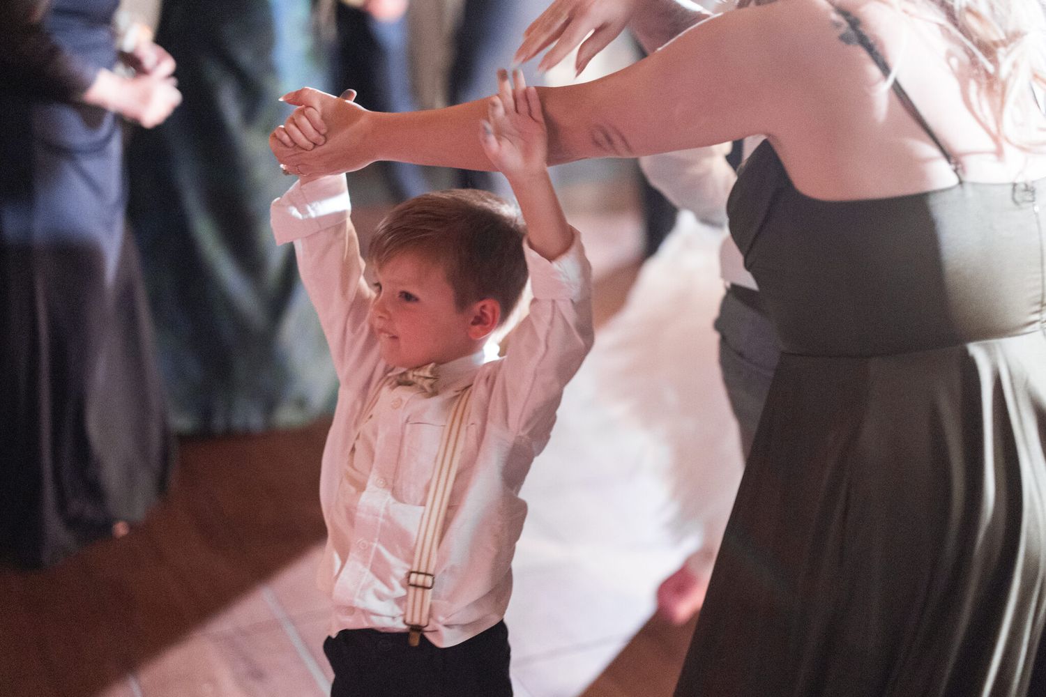 Young guest dancing on the dance floor at a Vista Canmore wedding reception