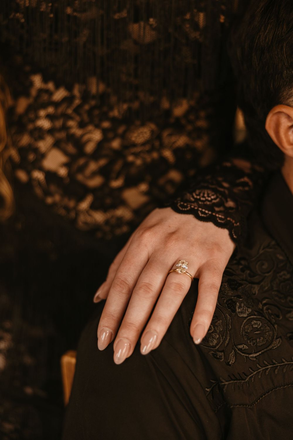 Bride shows off ring in 2nd Street Bistro at her welcome party in her black western lace dress captured by Local Livingston Photographer