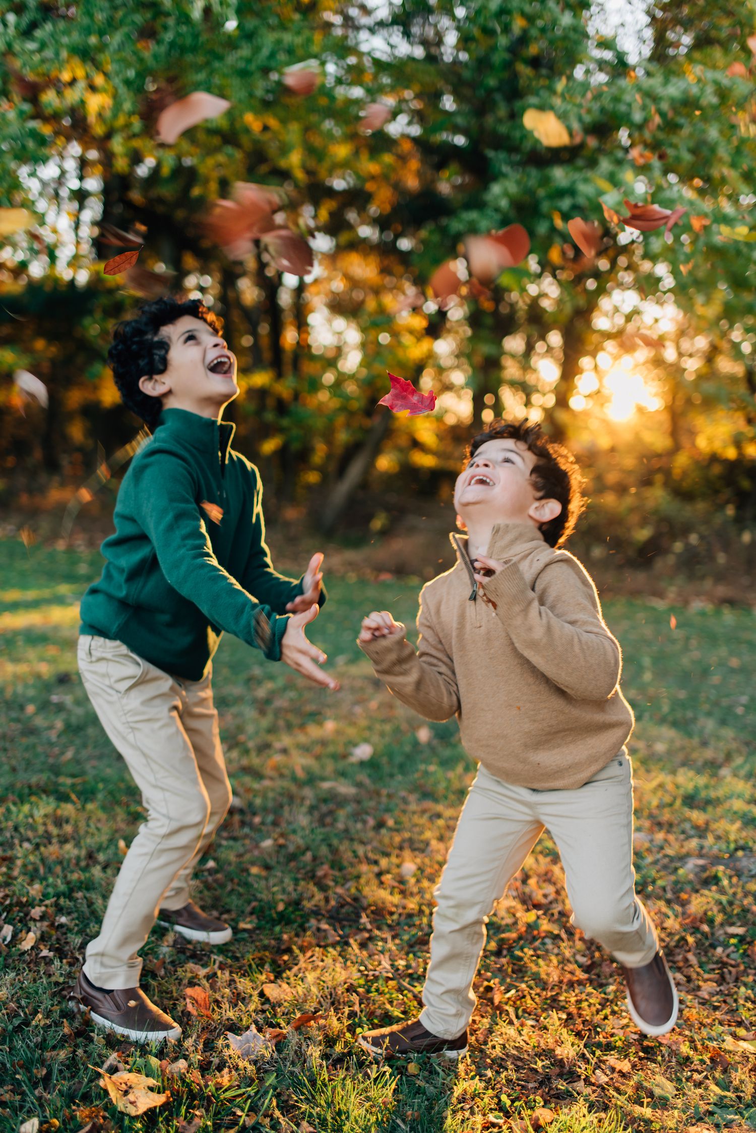 Kids throwing leaves in fall foliage in Pittsburgh, PA