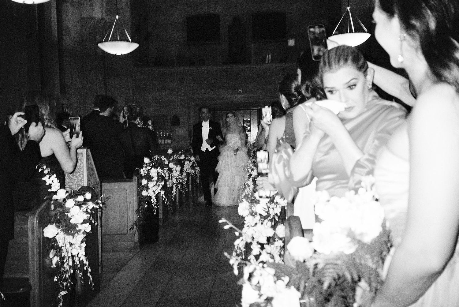 Wedding reception guests dancing and celebrating on a crowded dance floor.