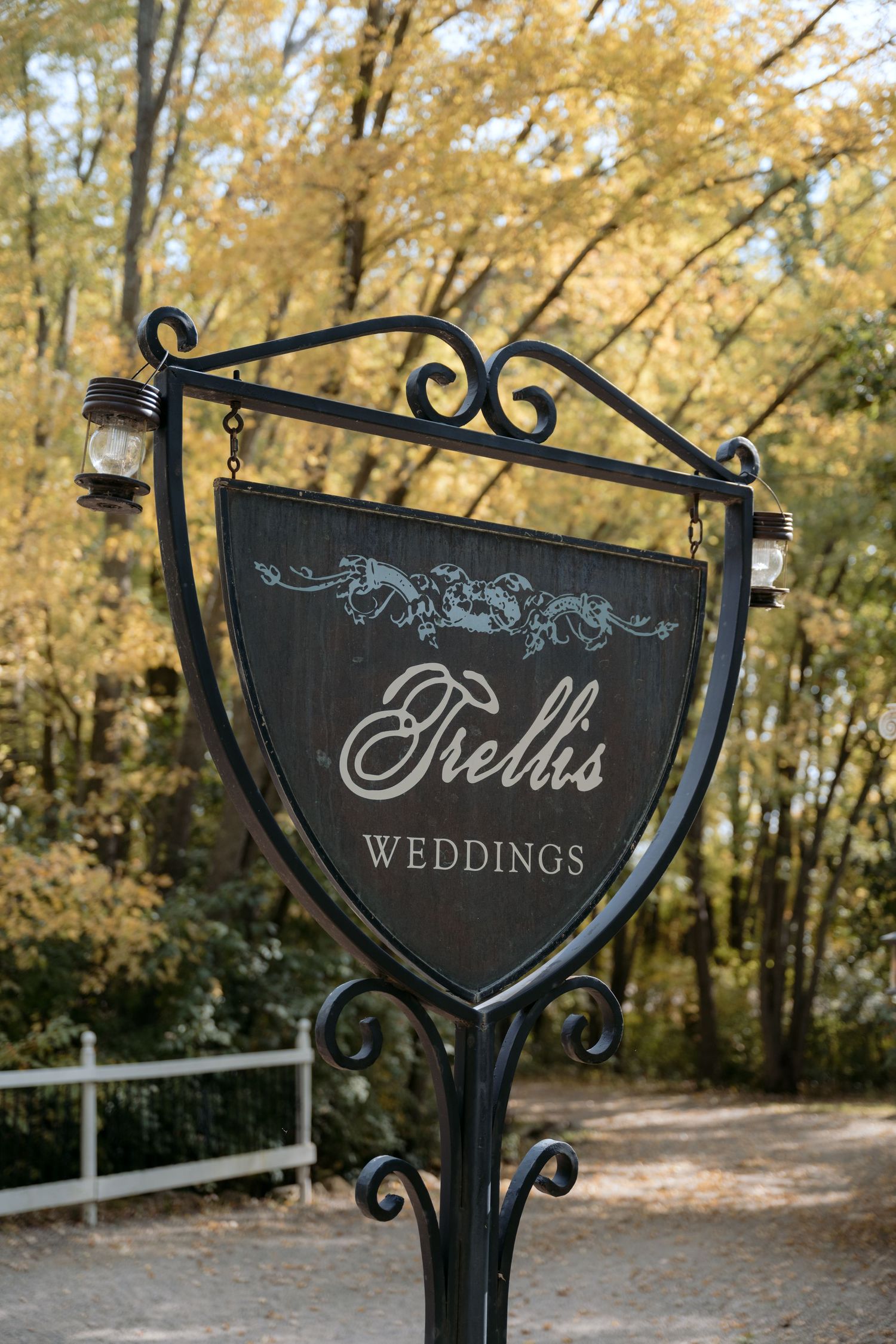 Trellis Weddings entry sign surrounded by fall colors in Stillwater, MN.