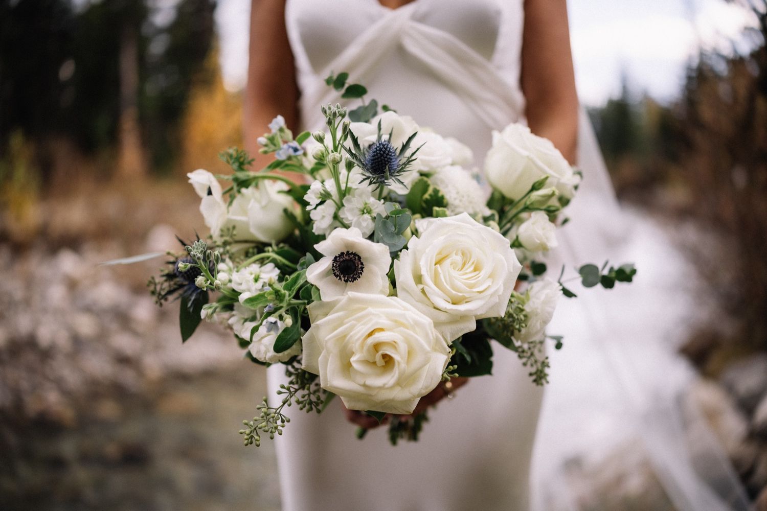 White rose and thistle bouquet by Fleurish at a Lake Louise wedding