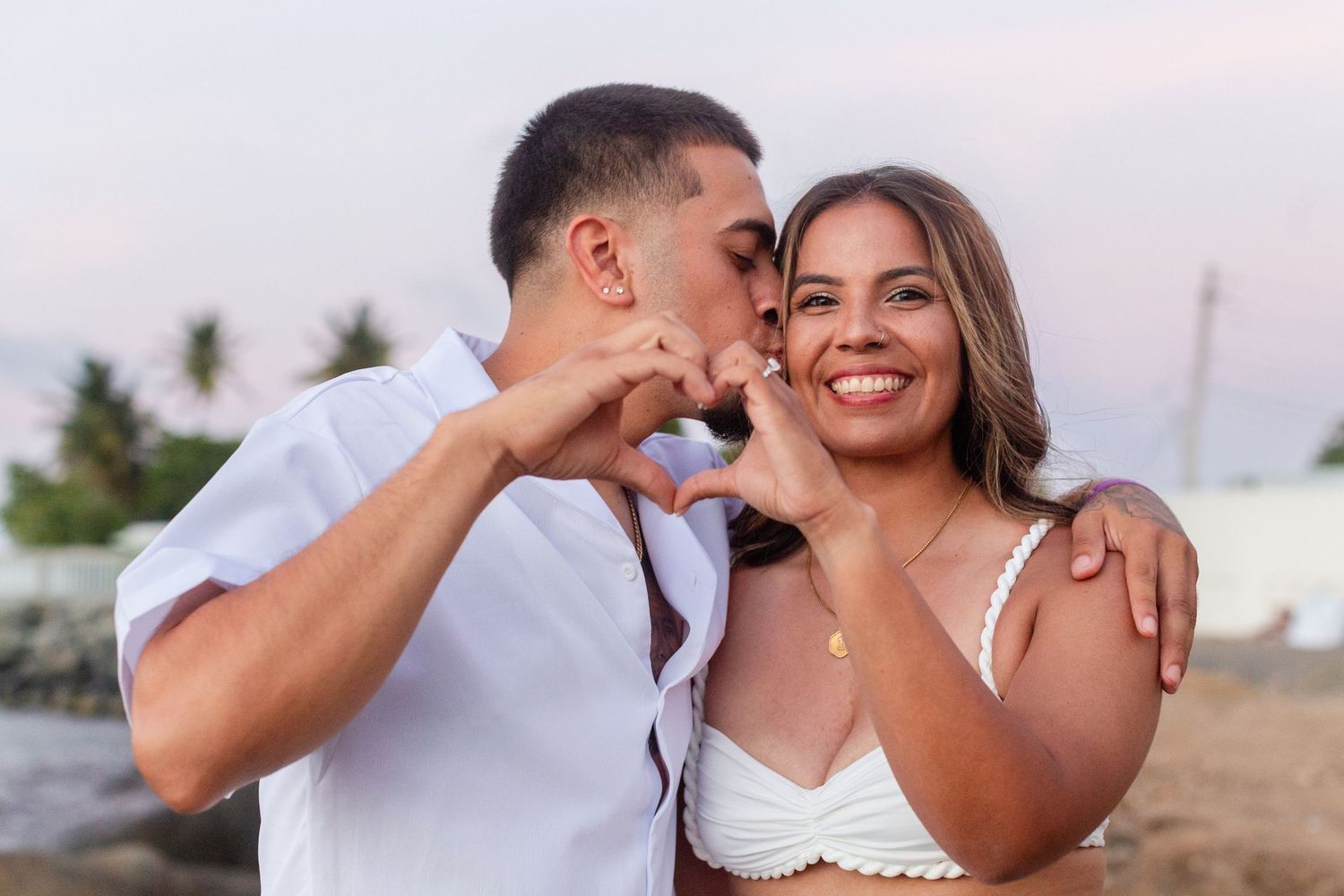 Couples portrait. Man and woman making a heart shape with their hands. Río Grande, Puerto Rico.