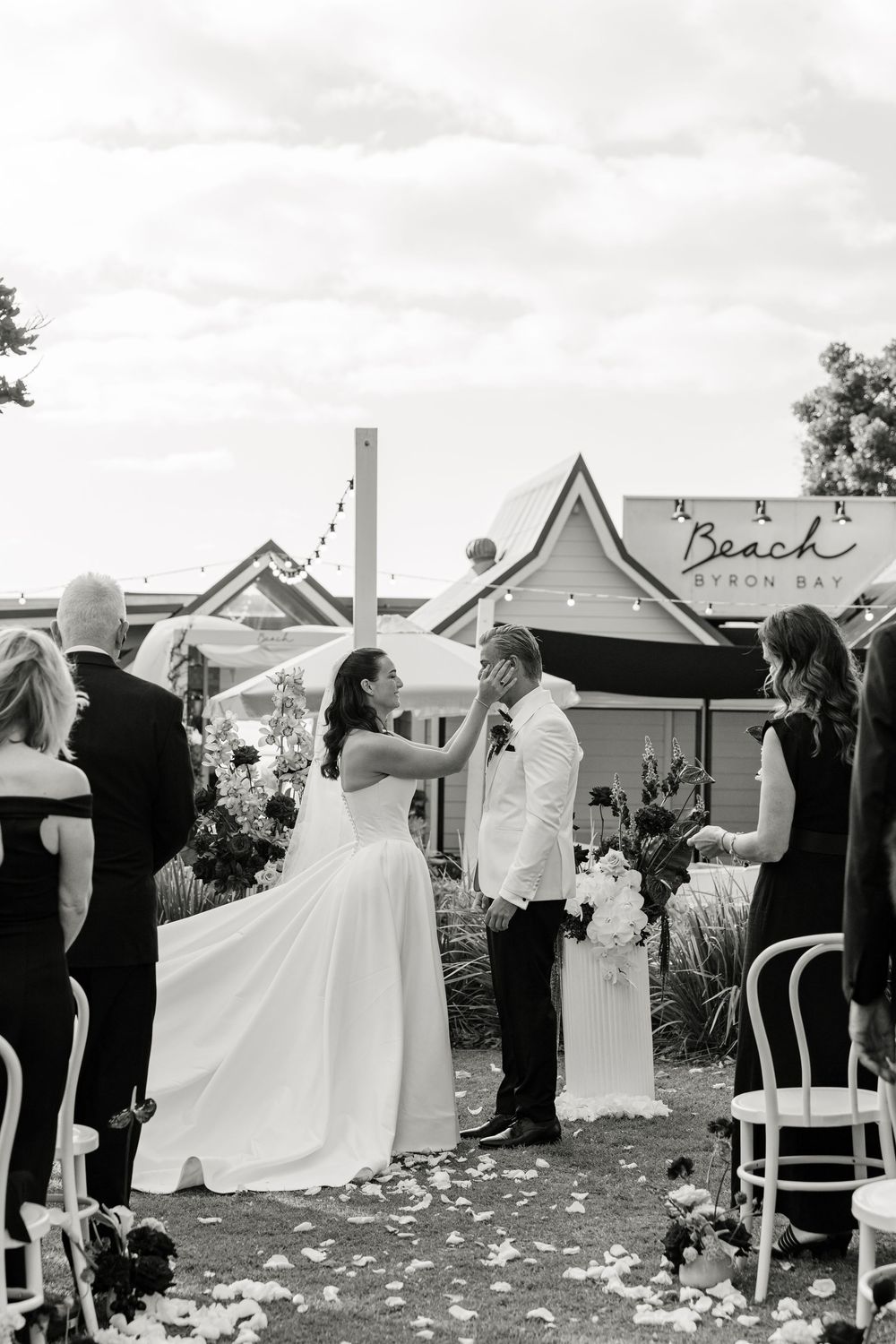 Bride and groom exchanging rings during their intimate garden wedding ceremony in Byron Bay.
