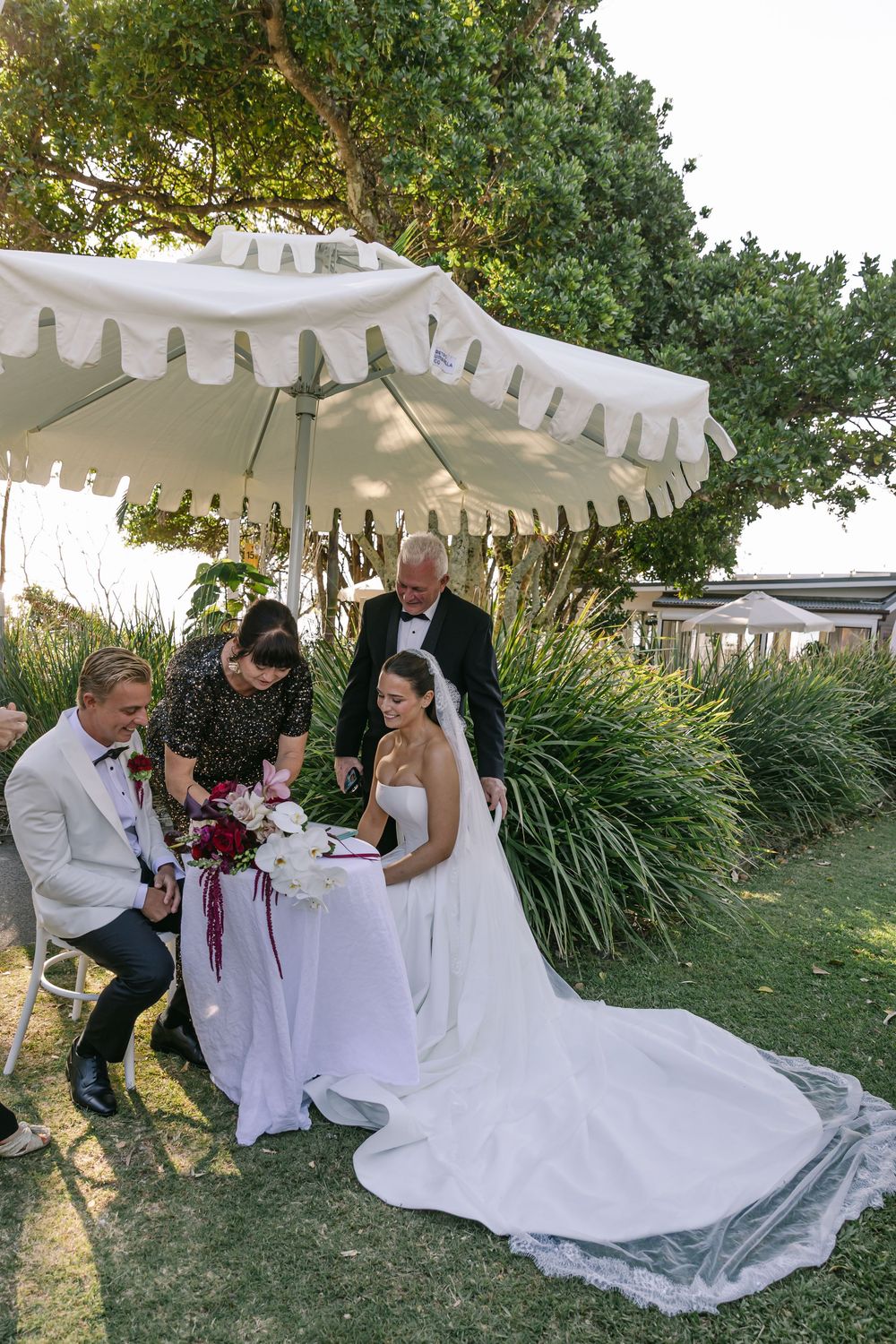 Bride and groom relaxing with loved ones after their intimate Byron Bay wedding celebration.