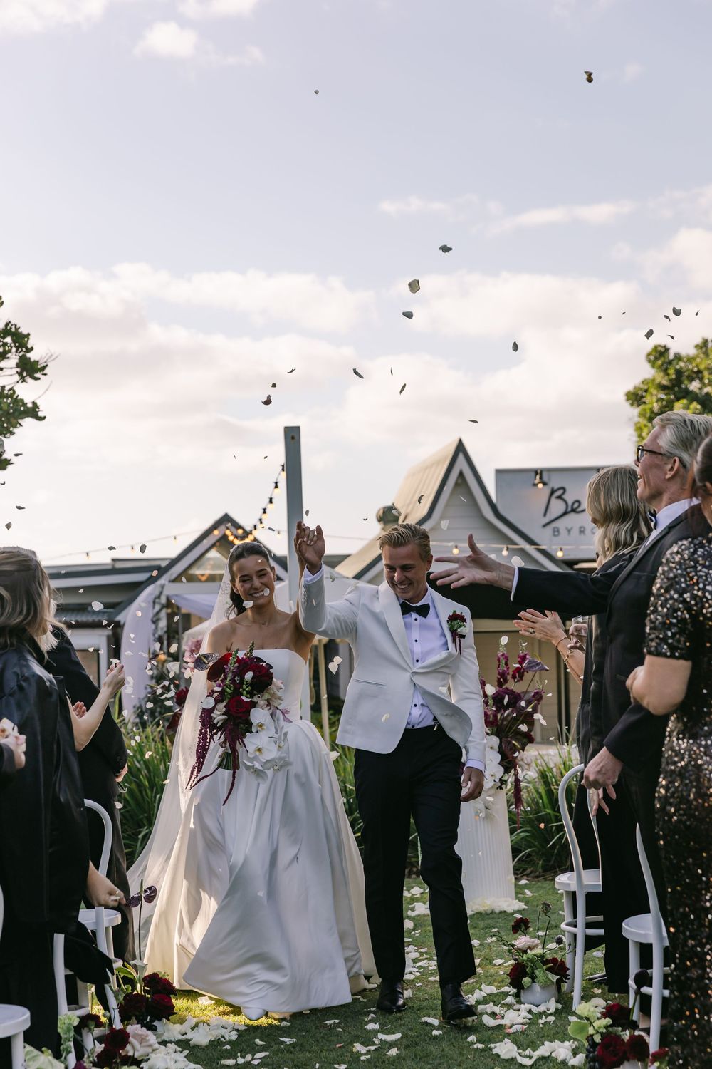 Newlyweds celebrating with family and friends following their romantic Byron Bay wedding ceremony.