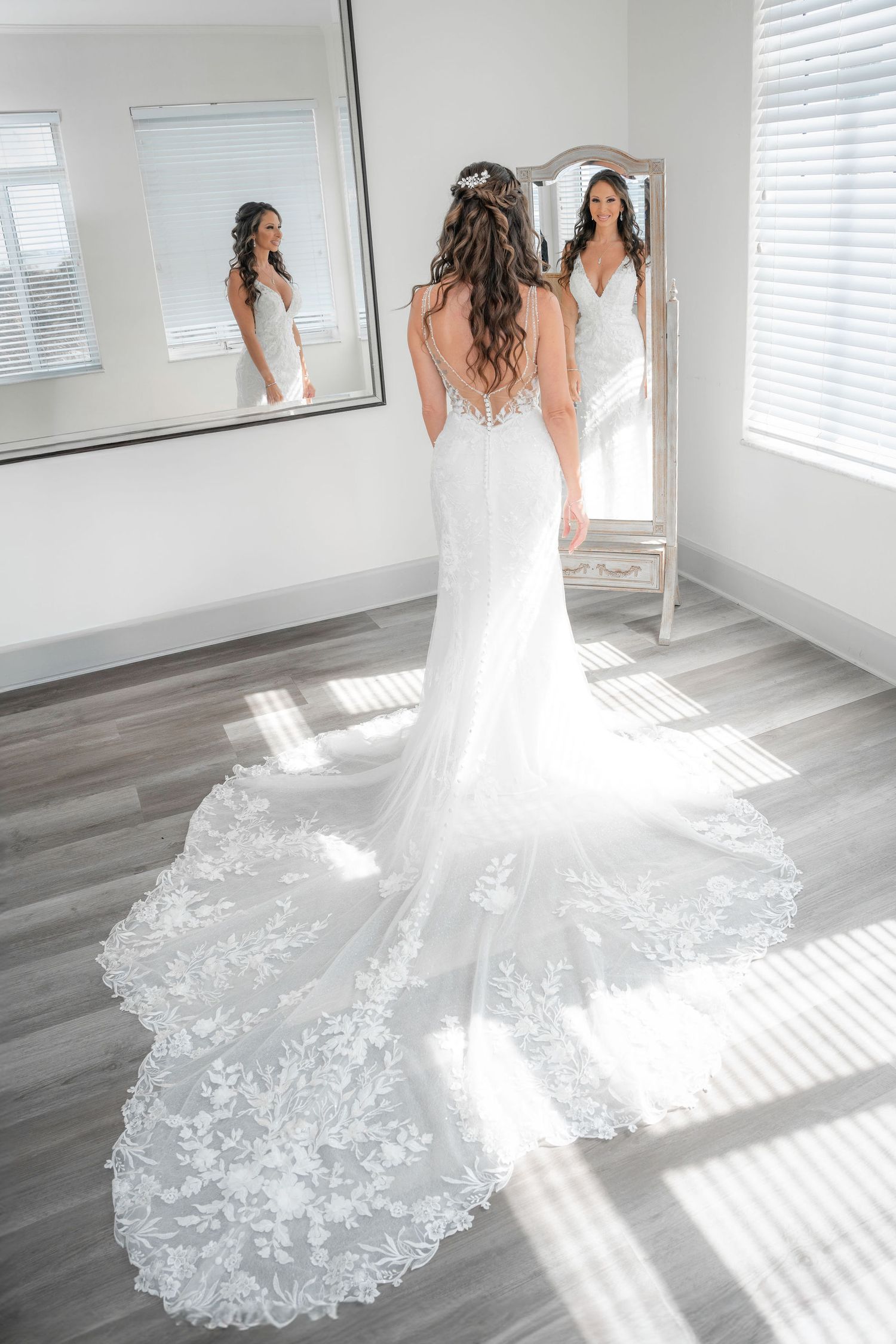 Bride seeing herself in her gown in front of the bridal suite mirror at the Mansion at Tuckahoe