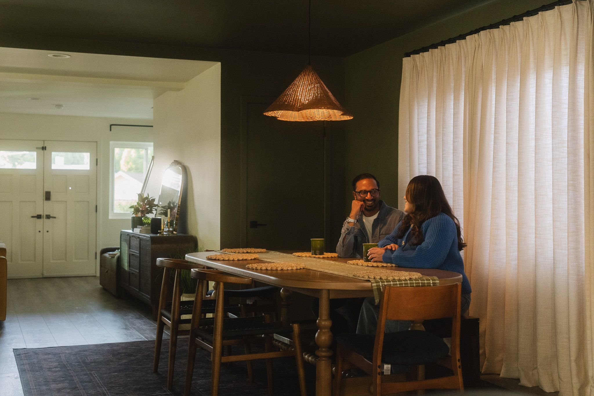 Expecting couple talking at their dining table during a relaxed Pasadena maternity session