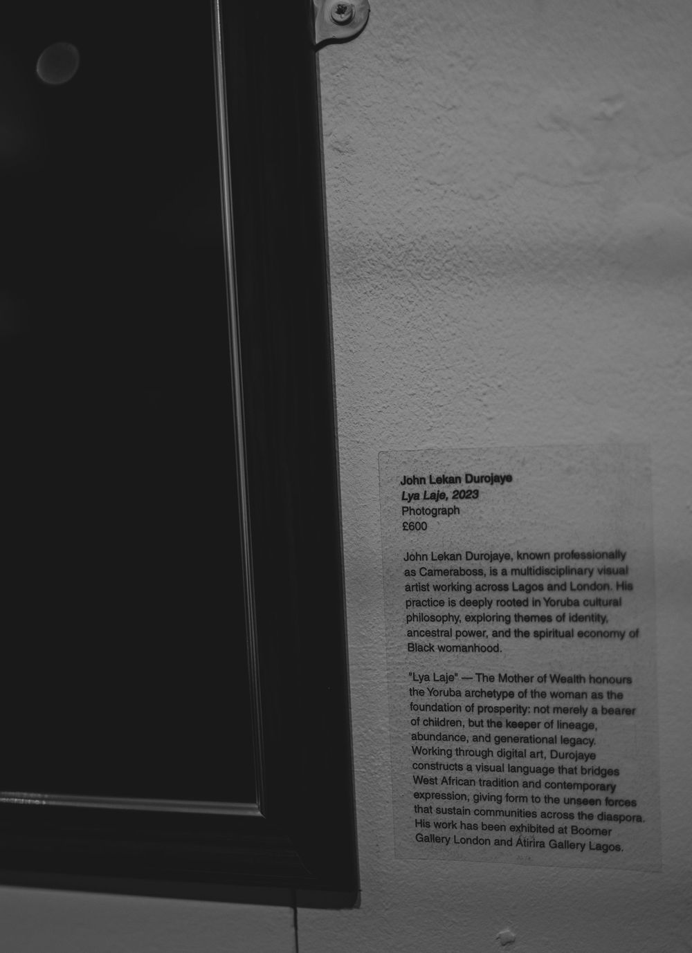Museum wall label for John Lakan Dunjoye's 2025 photography work Lye Laje displayed in a gallery.
