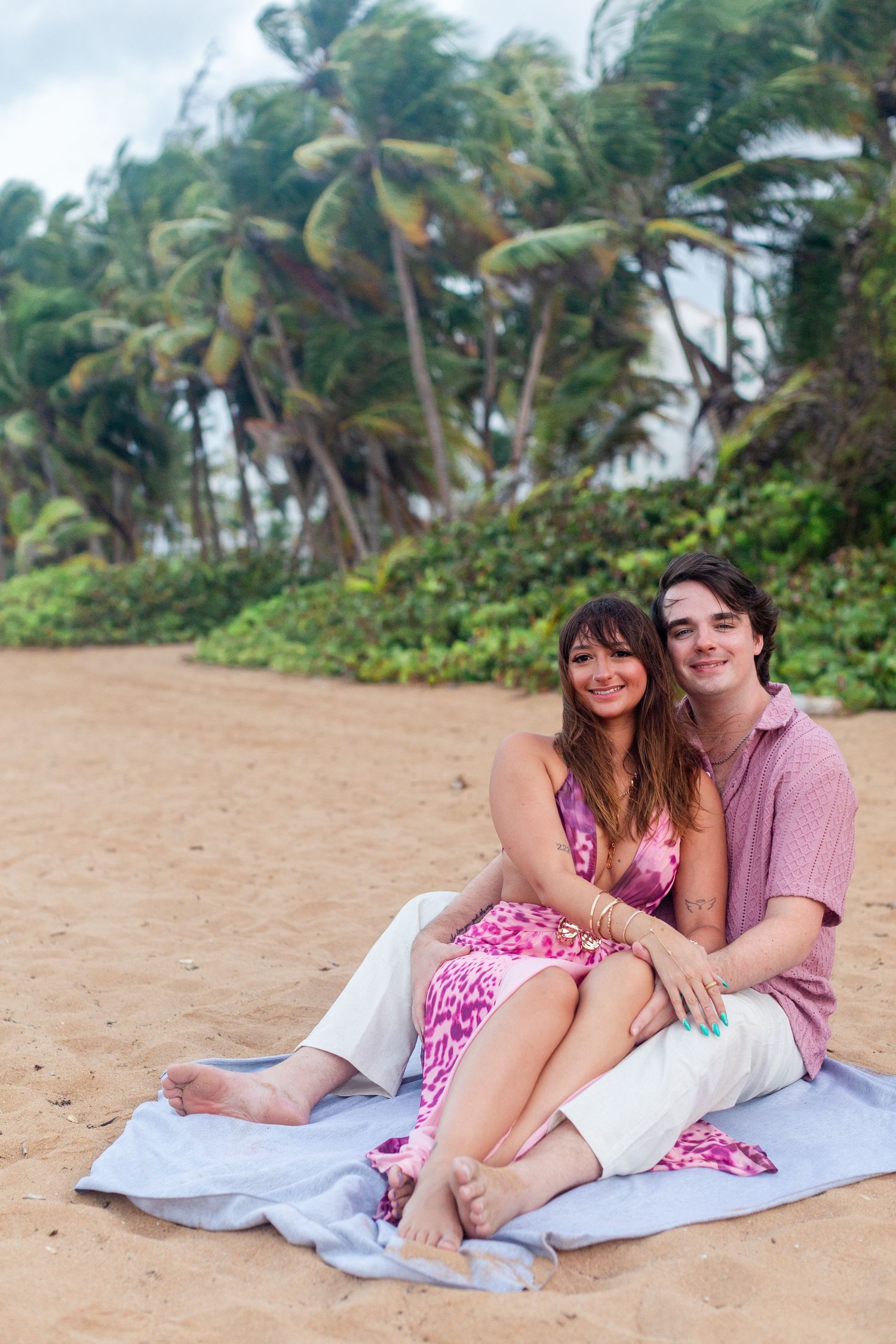 Couples portrait on the beach. Seated on a blanket. Río Grande, Puerto Rico.
