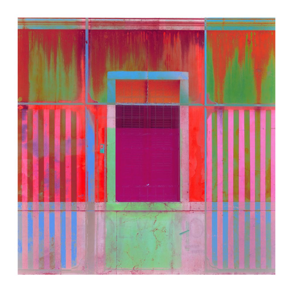 Colorful geometric architectural photography of building facade with red, green, blue and purple stripes.