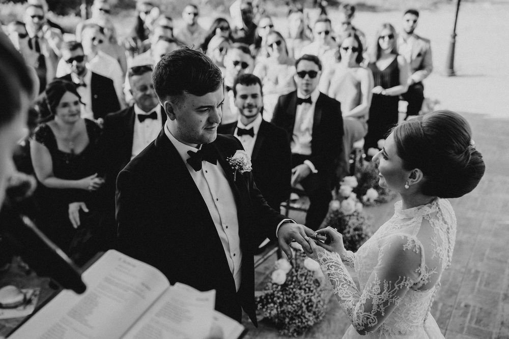 A black and white photo collage of wedding moments showing couples dancing and celebrating at a reception.