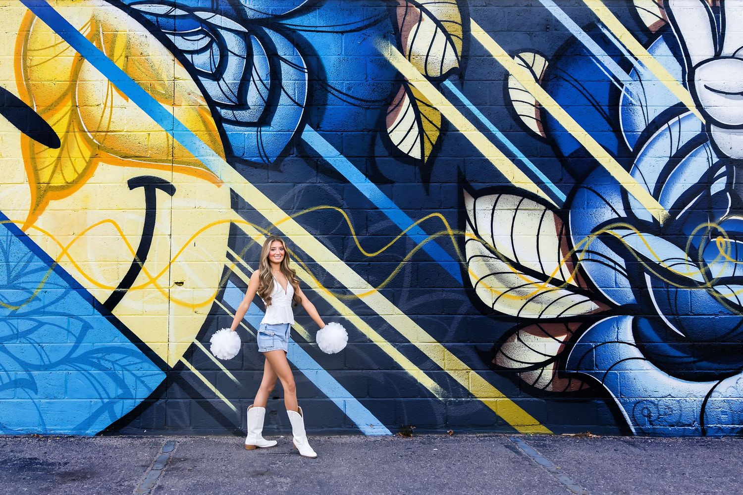 Colorful abstract street art mural featuring geometric shapes and swirling patterns in blue and yellow tones.