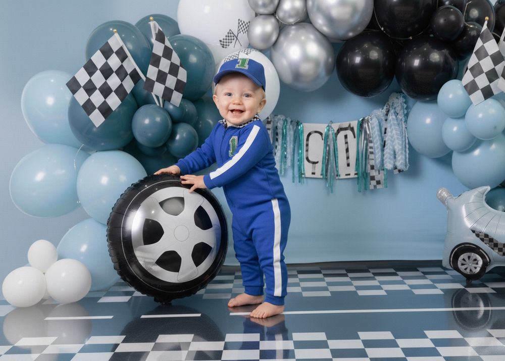 Blue and black balloon decorations with race car theme and checkered pattern set up for a children's birthday party.