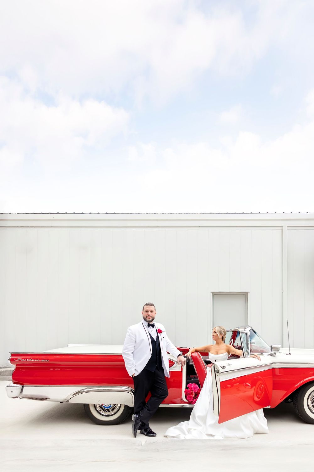 Classic red and white vintage car photographed against minimalist white backdrop. Editorial Wedding Photography