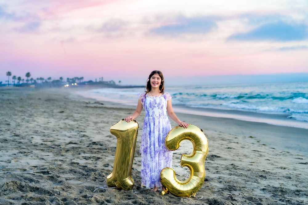 A series of beach photos showing gold number balloons and a purple dress against ocean waves at sunset.
