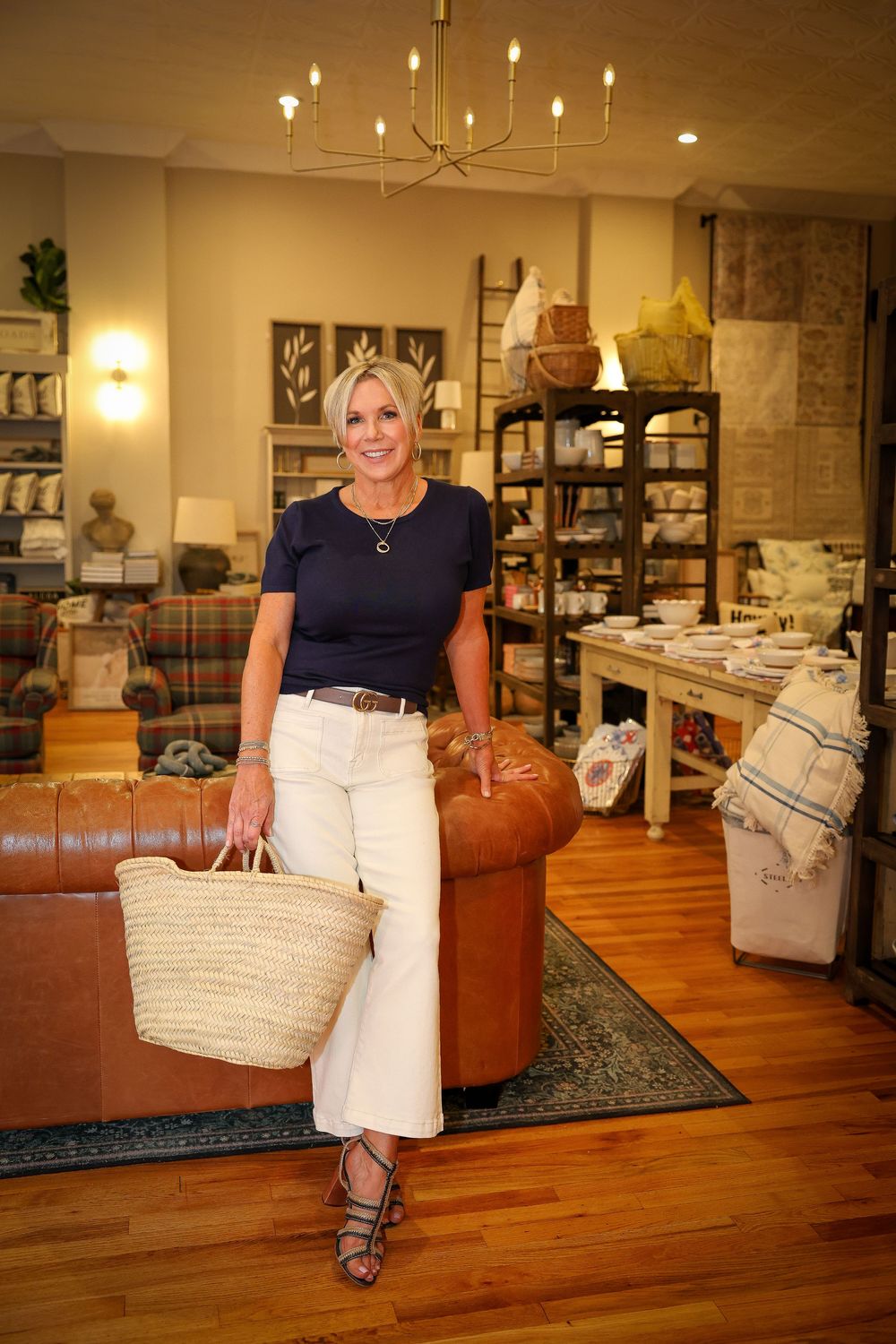 Warm-lit retail interior with leather furniture and hardwood floors.