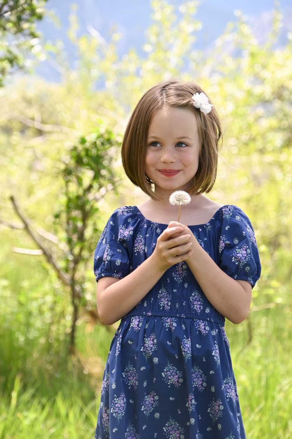 A sweet sequence of moments in a blue floral dress against a sunny yellow nature backdrop.