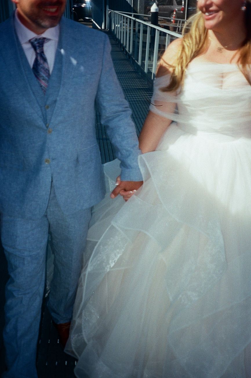 bride and groom holding hands and walking