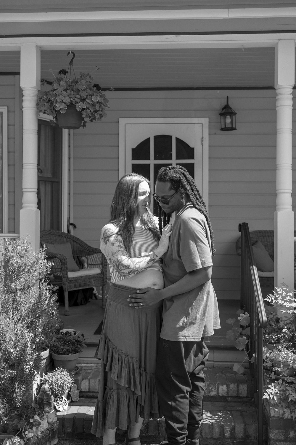 black and white couple photo in front of home