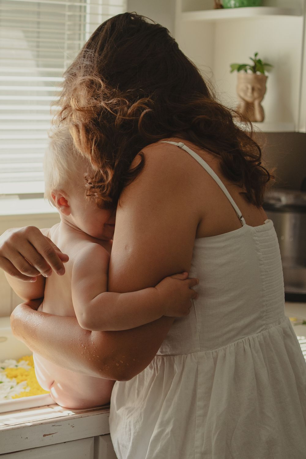 mom holding baby in the kitchen