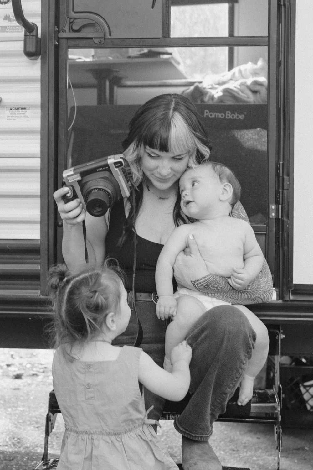 mom with a camera and a baby on her lap
