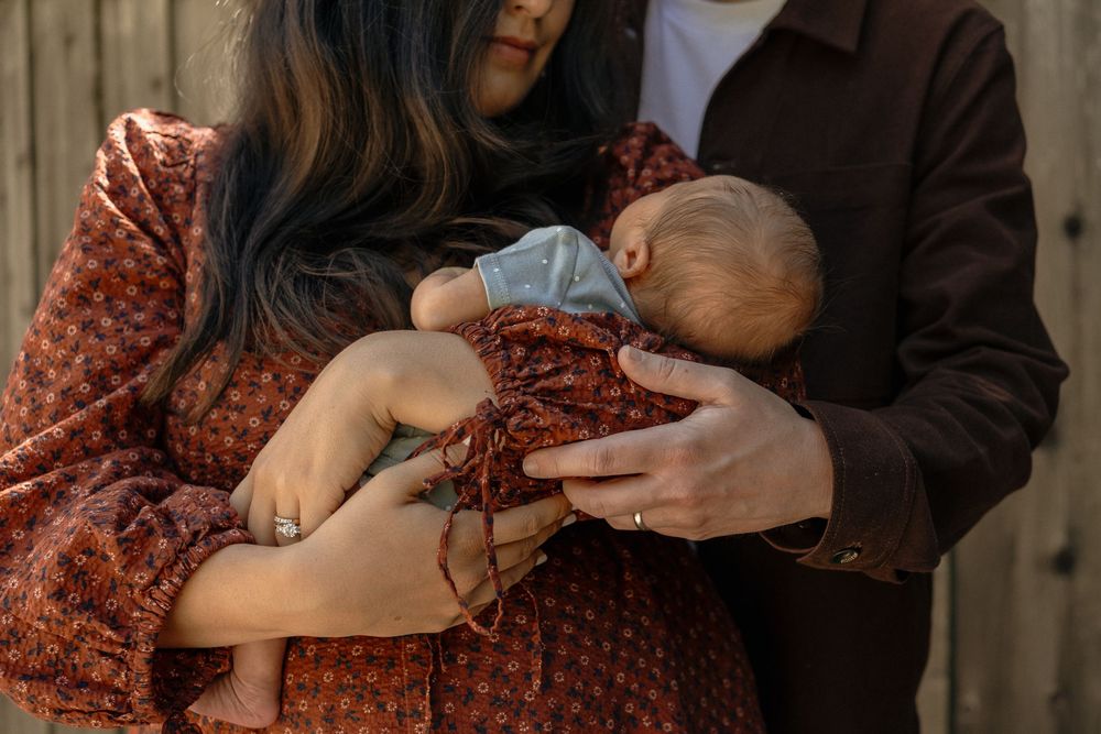 mom and dad holding a newborn