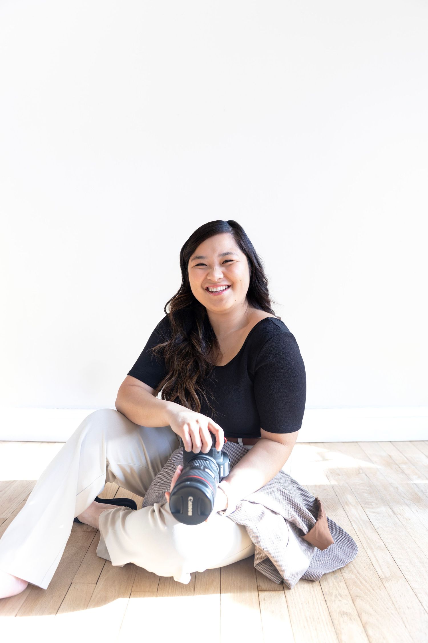 The woman behind LivingFlow smiling during a photography studio session.