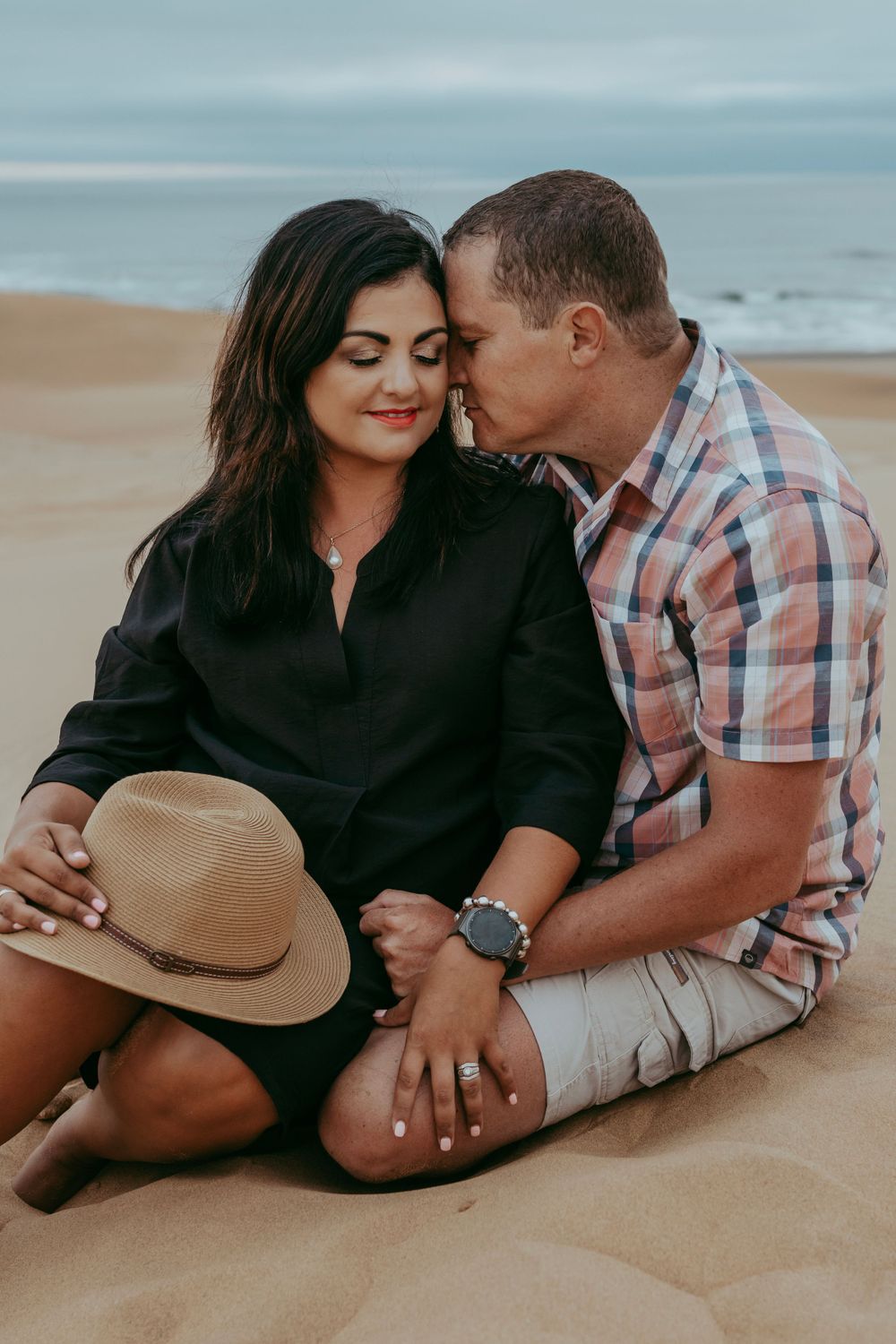 A family enjoying a photoshoot at the beach in Swakopmund, with the stunning backdrop of sand dunes and the ocean