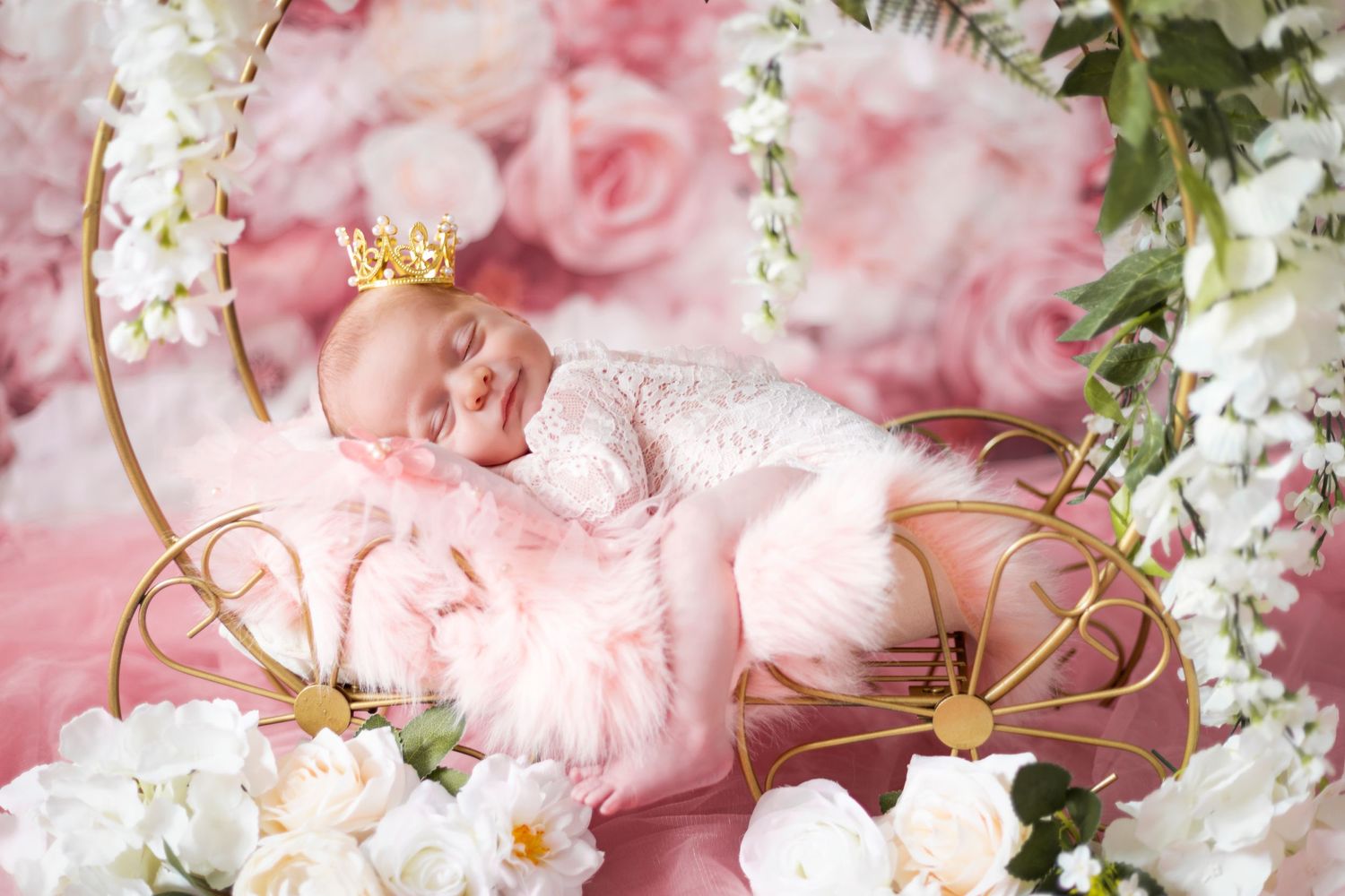 Romantic arrangement of pink roses and white flowers with golden highlights.