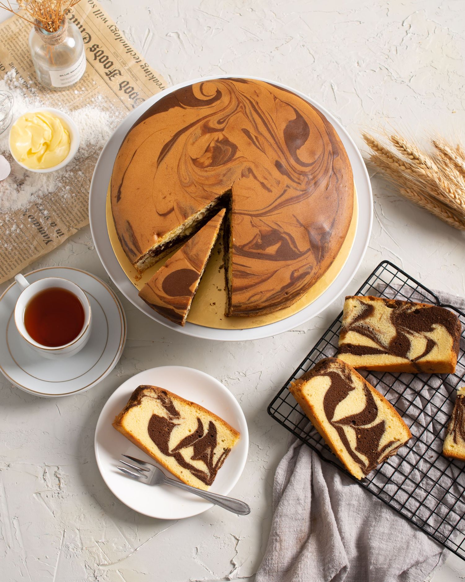Marble swirl cake and tea served with sliced portions on a cooling rack.