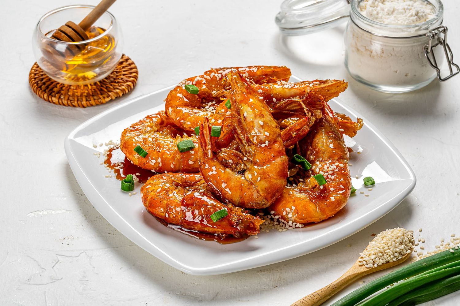 Spicy breaded shrimp arranged on plates with garnish and dipping sauce.