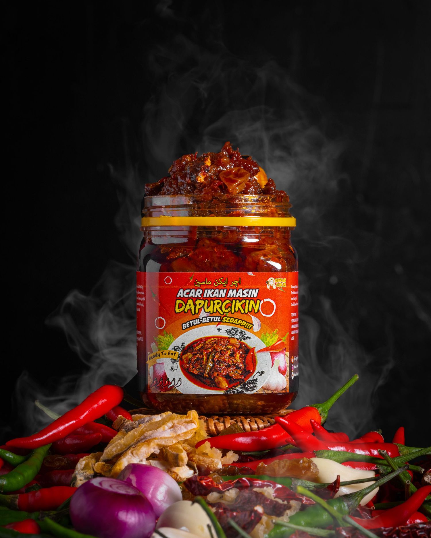 Dramatic shot of spicy sambal jar with steam and fresh ingredients on dark background.
