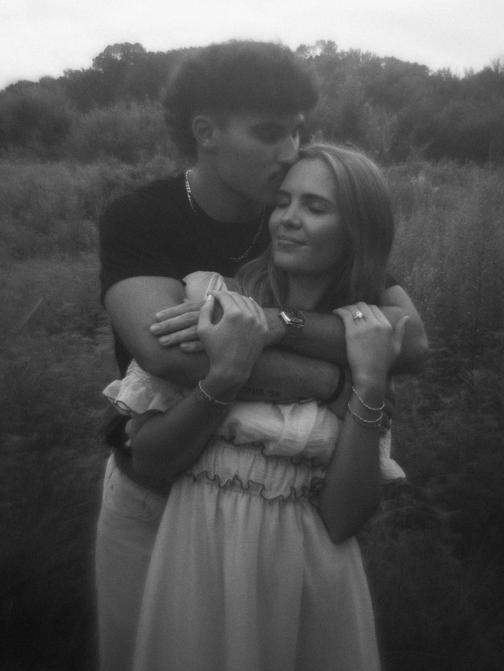 Black and white photos of a couple sharing playful moments outdoors.