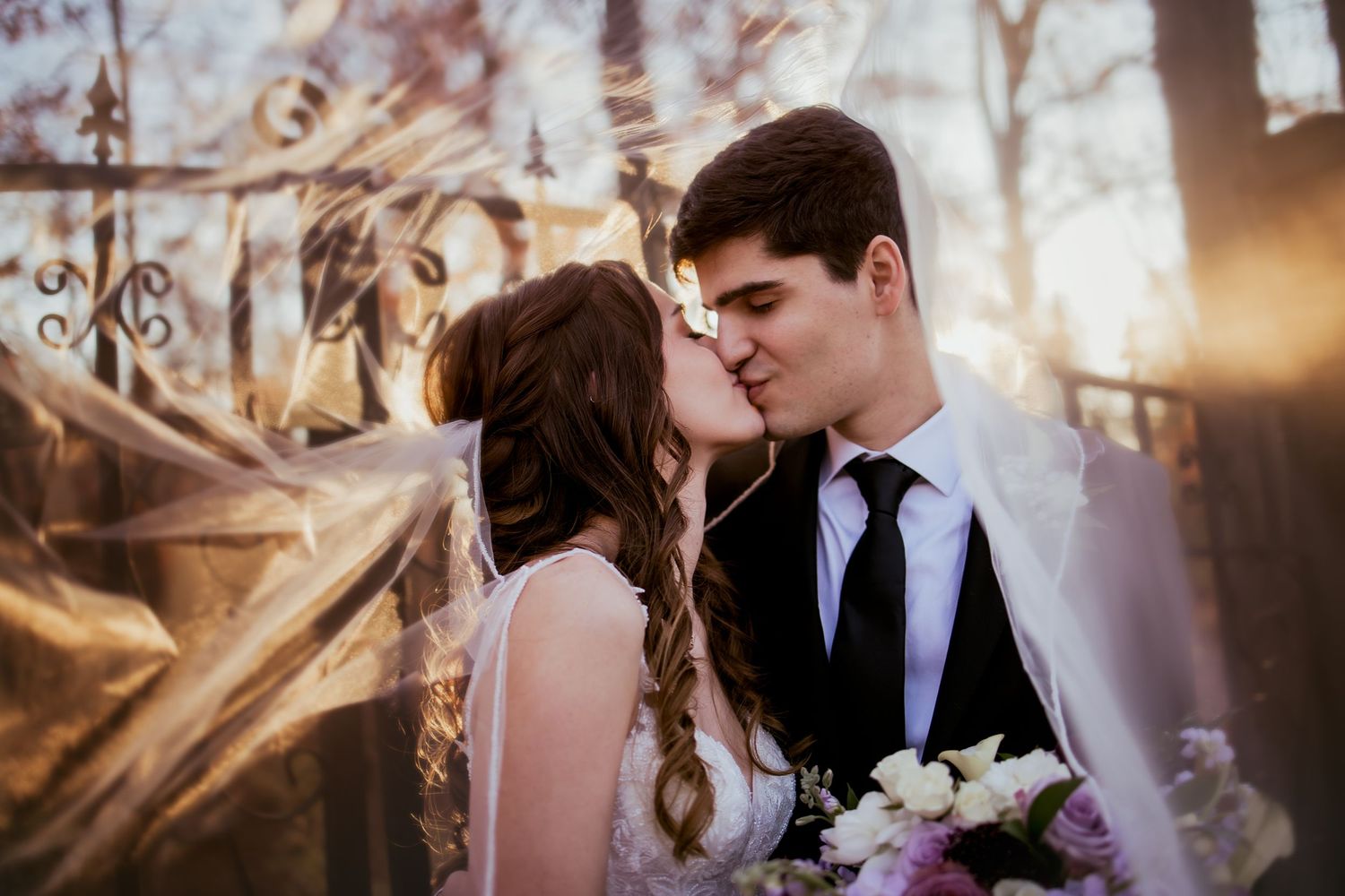 Bride and groom, kissing at sunset at the Bluffs at Connor Prairie, located in fishers Indiana