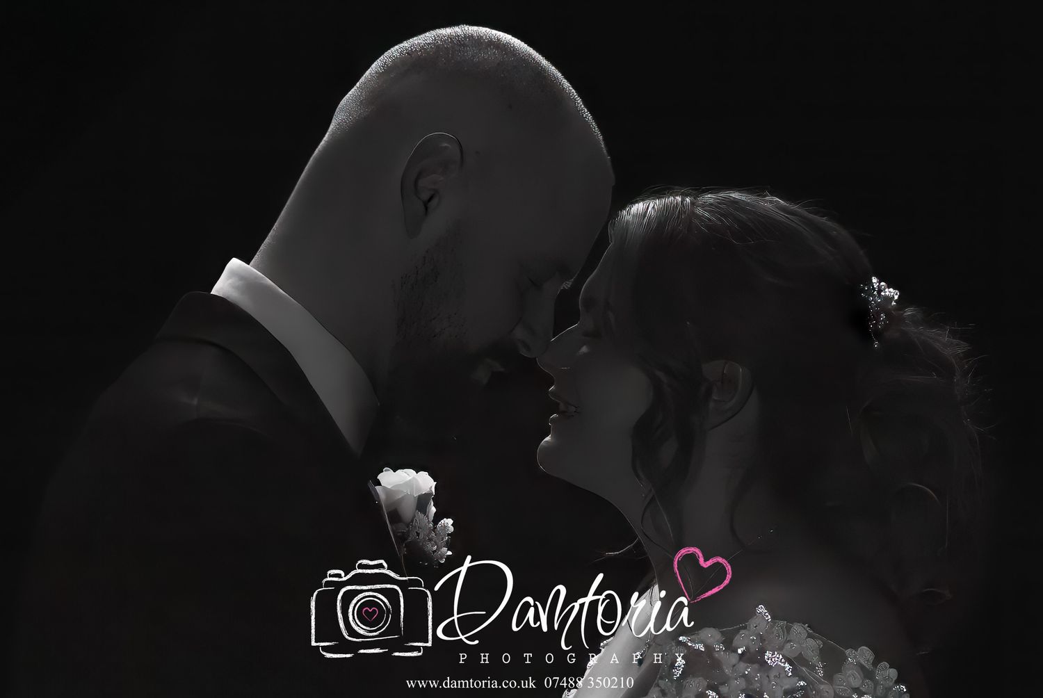 Intimate black and white portrait of a couple sharing a tender moment at their wedding.