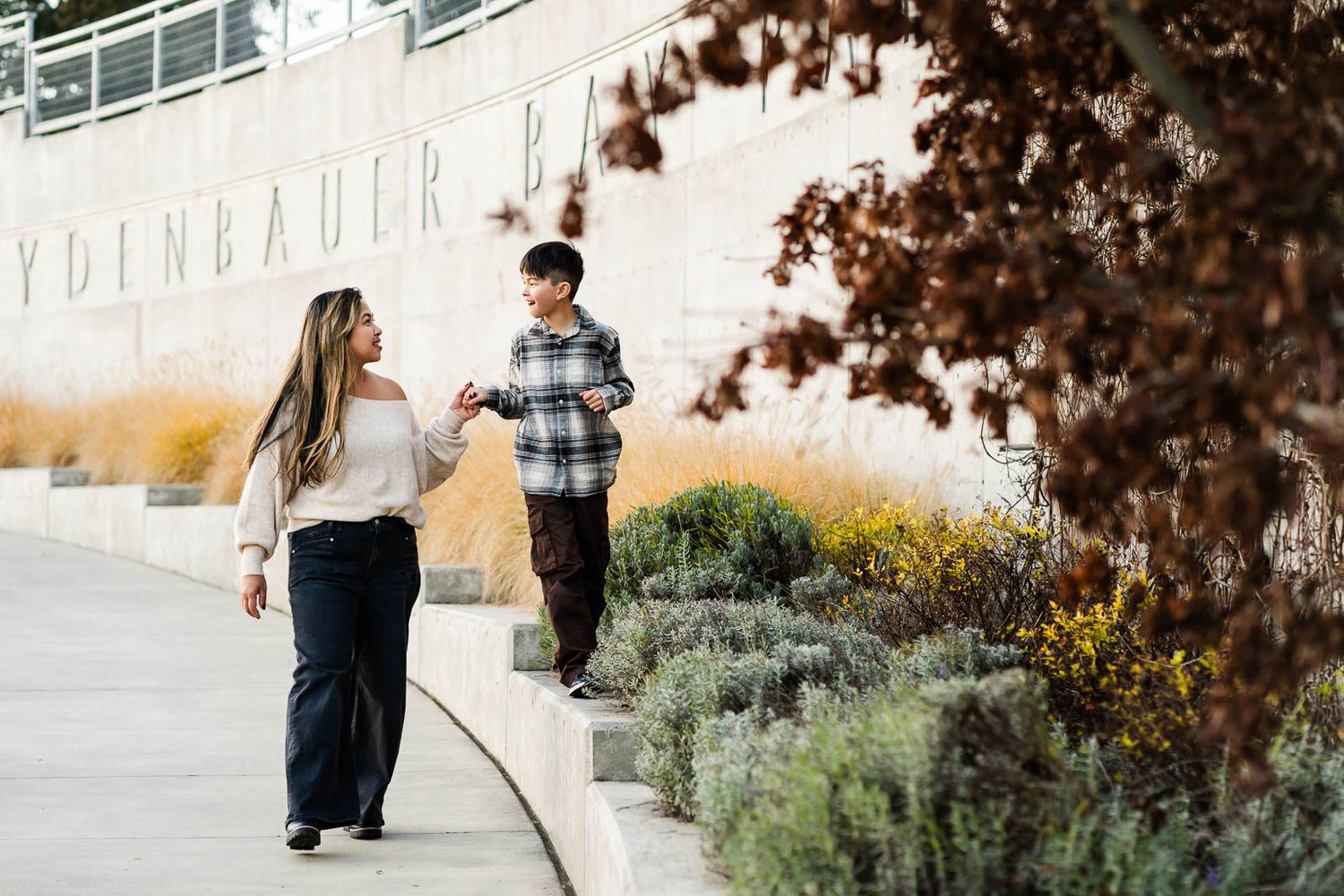 Mother and son walking hand in hand at Meydenbauer Bay Park.
