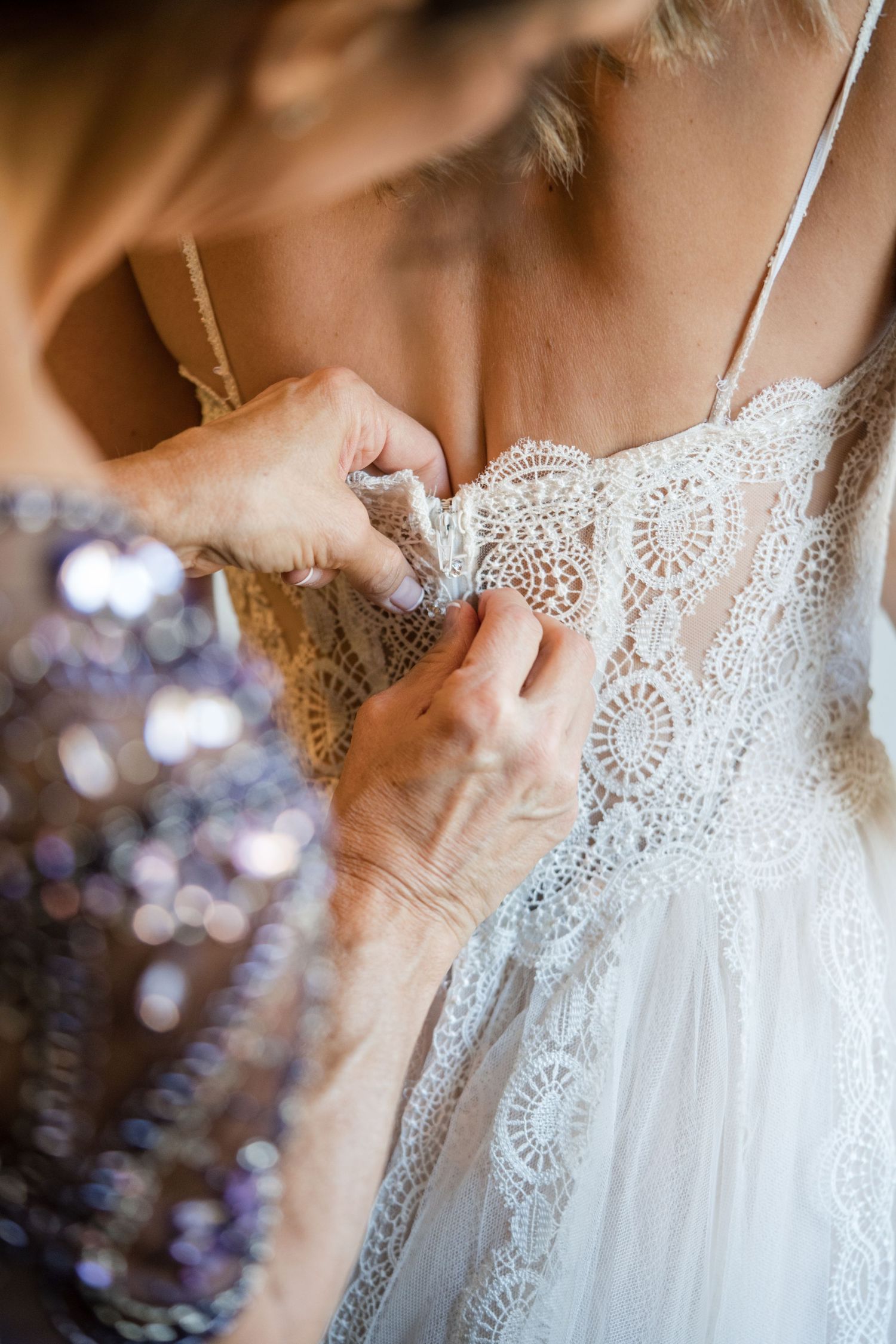 Mother of the Bride putting the dress on.