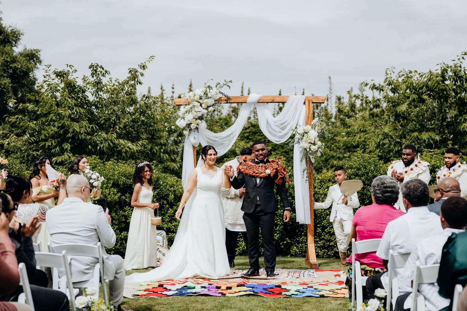 Collage of outdoor wedding ceremony scenes showing floral arrangements, guests seated on chairs, and natural garden setting.